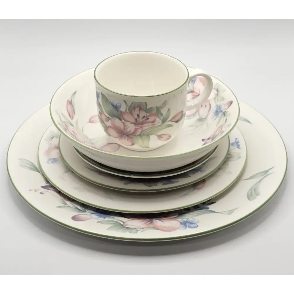Set of floral ceramic dinnerware on a white background