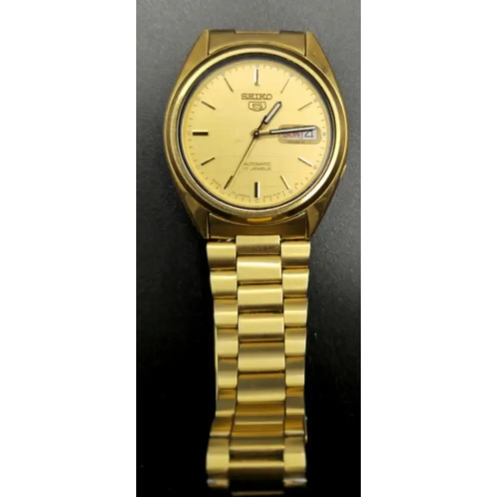 Gold Seiko watch on a dark background