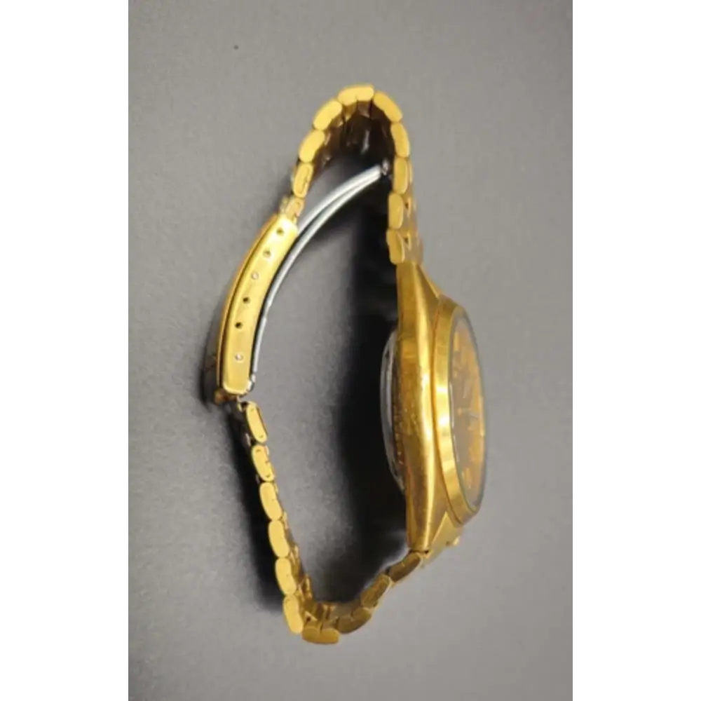 Gold watch on a gray background
