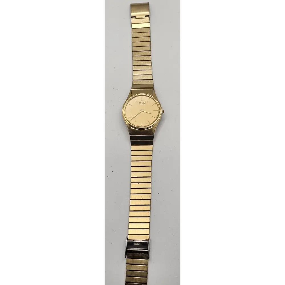 Gold wristwatch with a metal band
