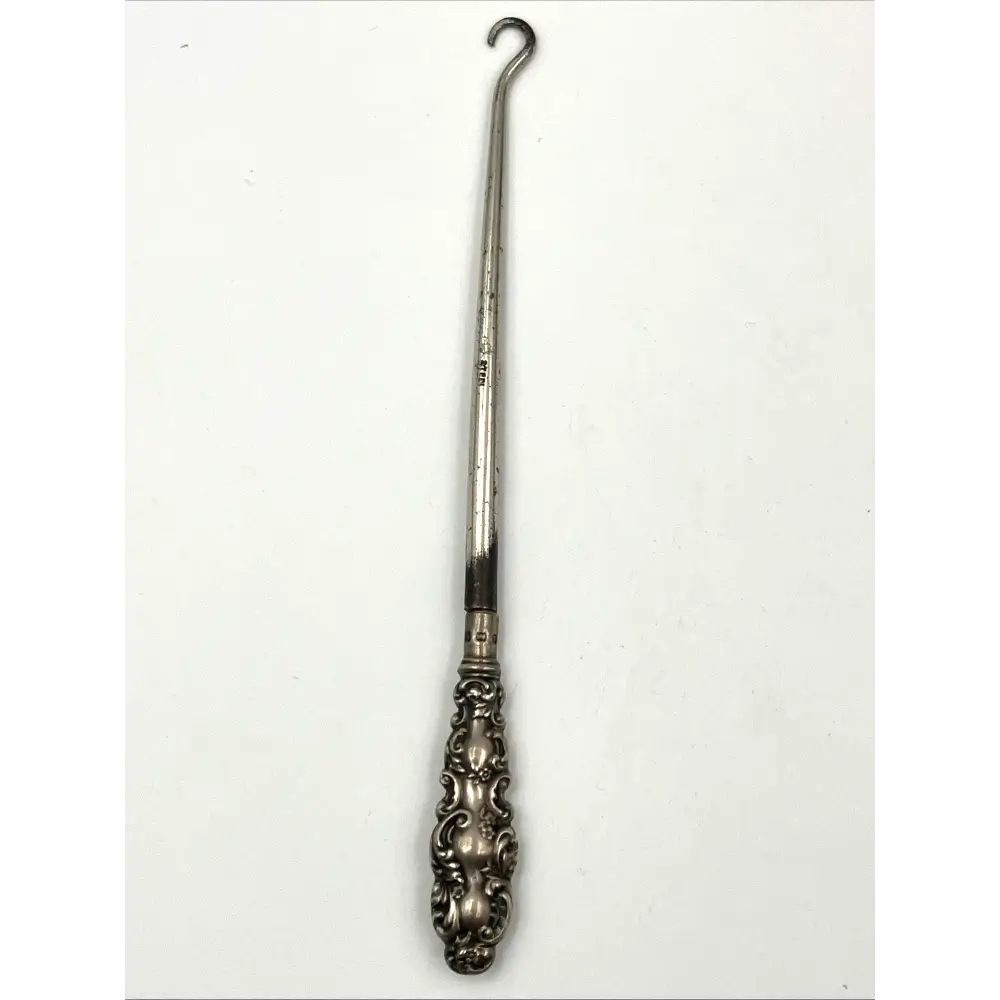 Detailed craftsmanship of 1900 sterling silver shoehorn and button hook