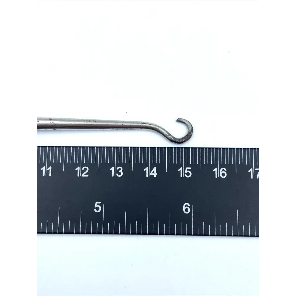 Metal hook next to a ruler