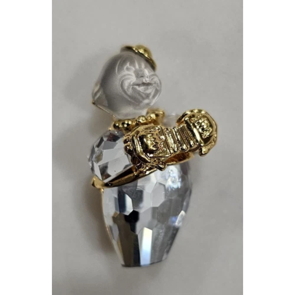 Crystal pendant with gold accents on a light gray background