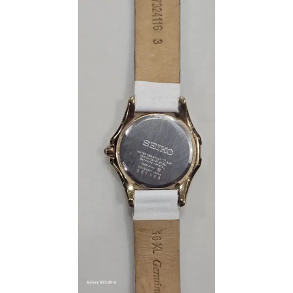 Seiko watch with a white strap on a gray background