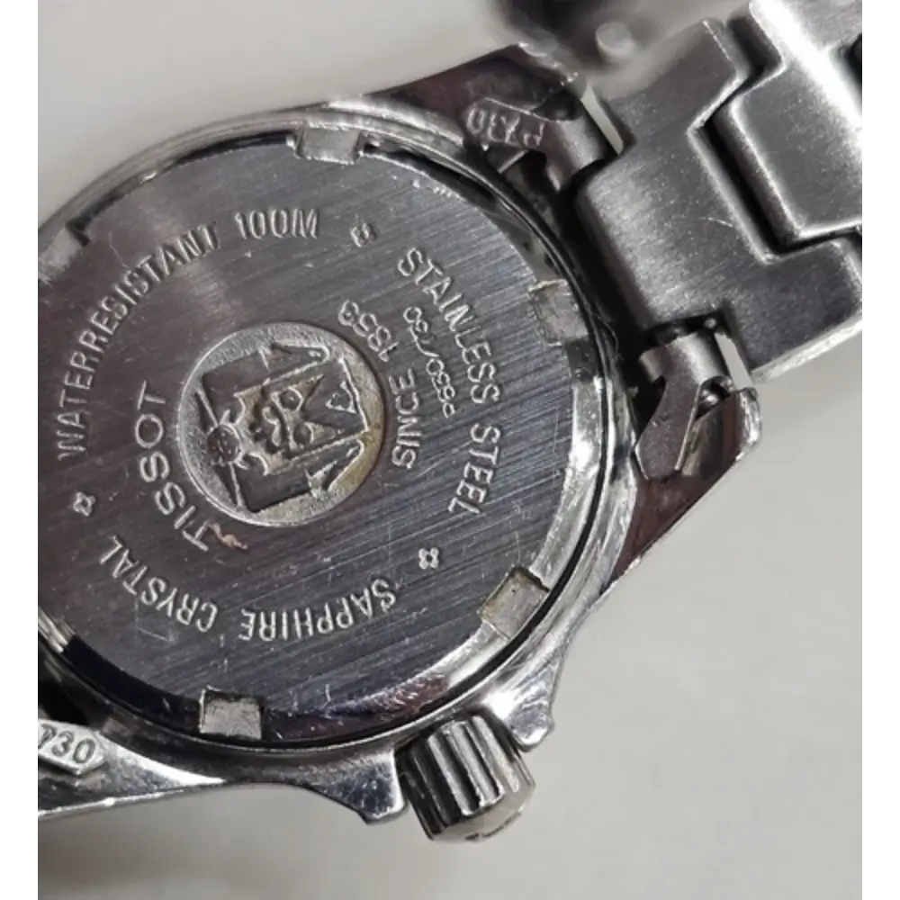 Back view of a Tissot watch with branding and specifications.