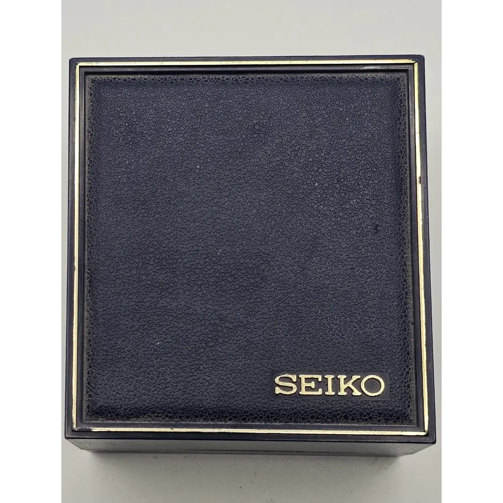 Black Seiko watch box on a light gray background