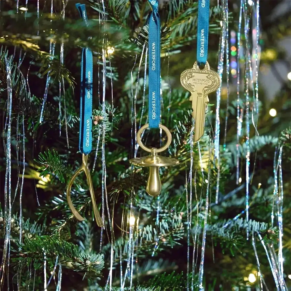 Decorative key and bell ornaments on a Christmas tree
