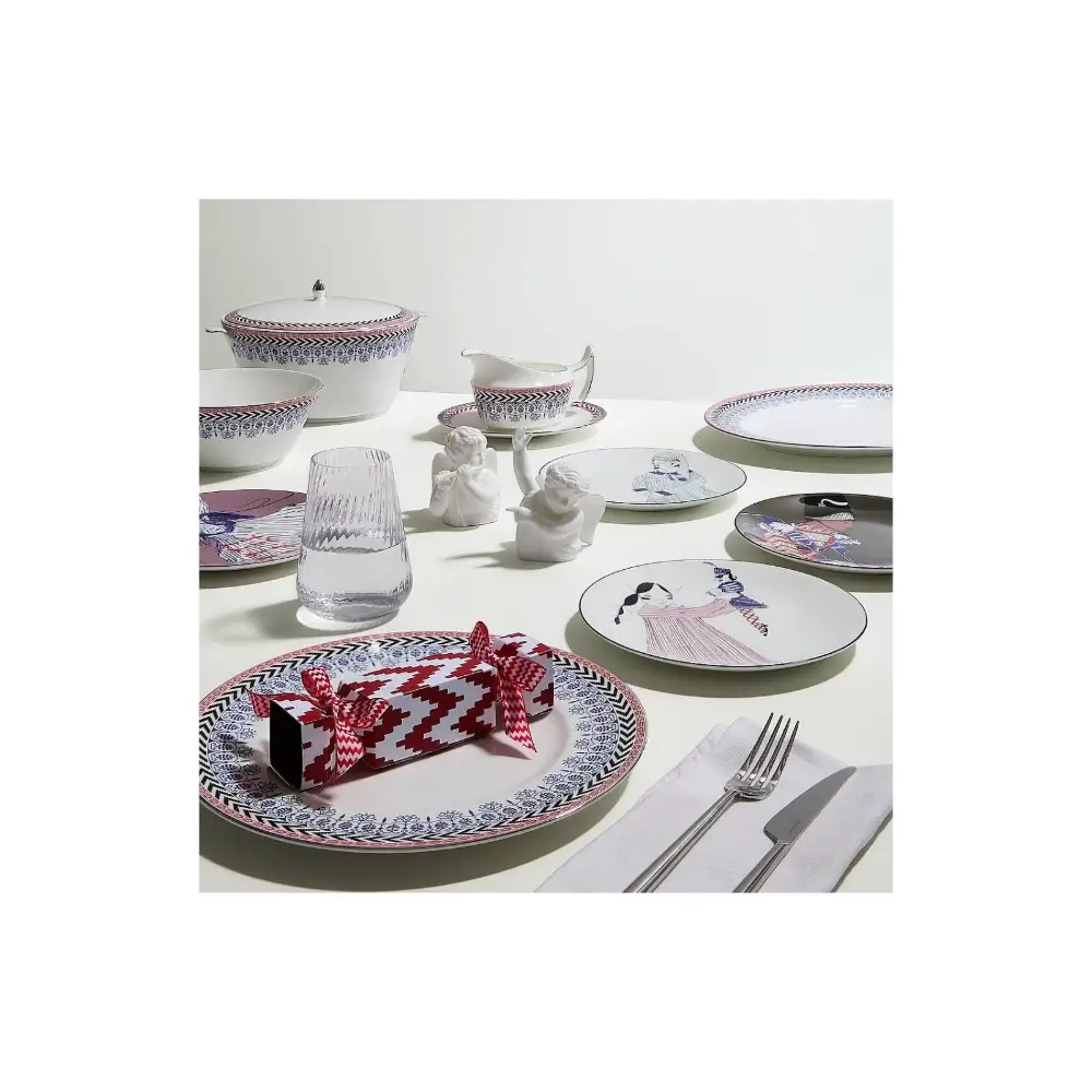 Dining table setting with patterned plates, glasses