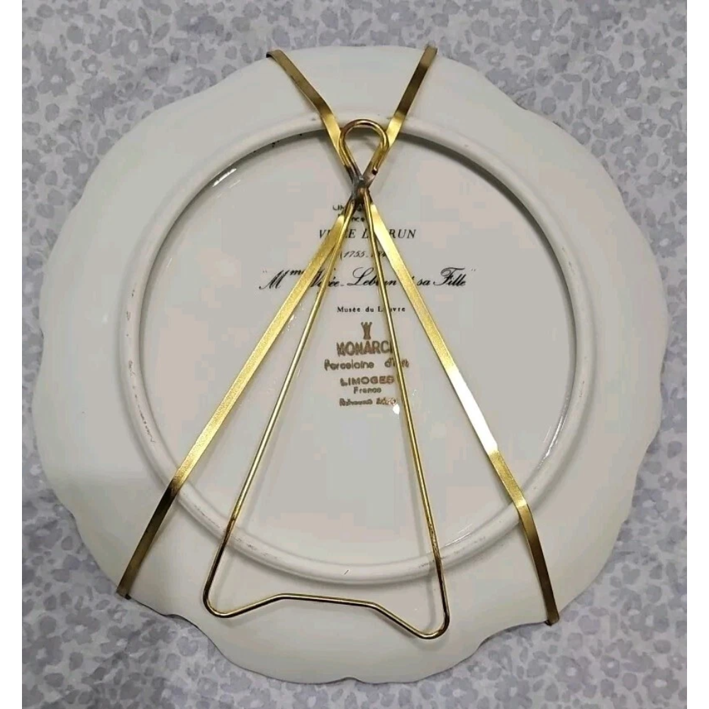 Gold decorative item on a white plate with 'Monarch' branding against
