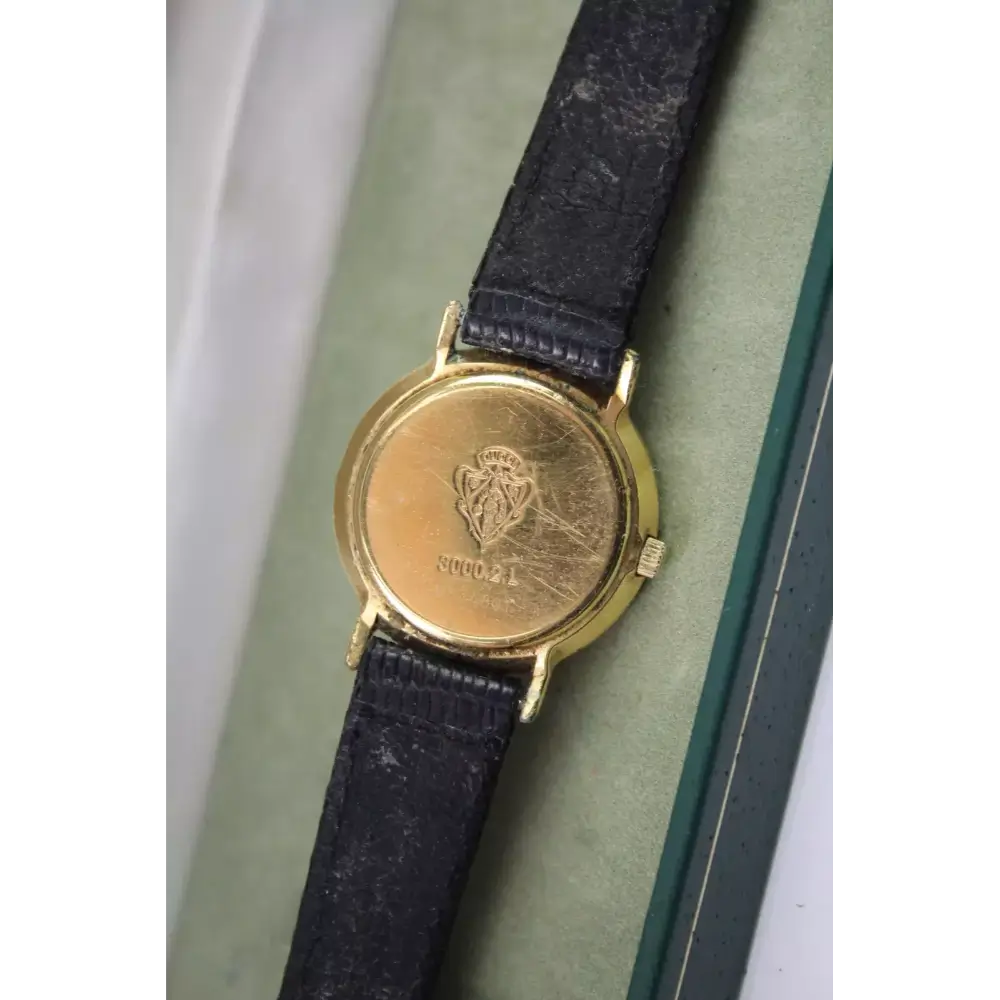 Vintage watch with gold face and black leather strap