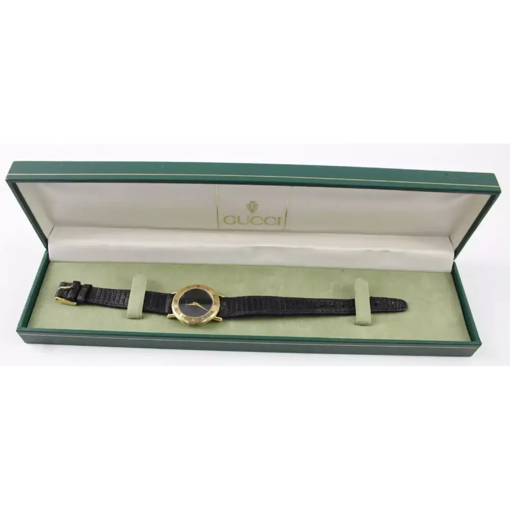 Gucci watch in a green box on a white background
