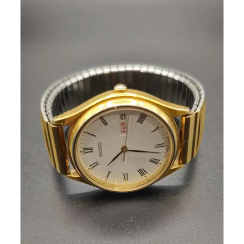 Gold wristwatch with silver band