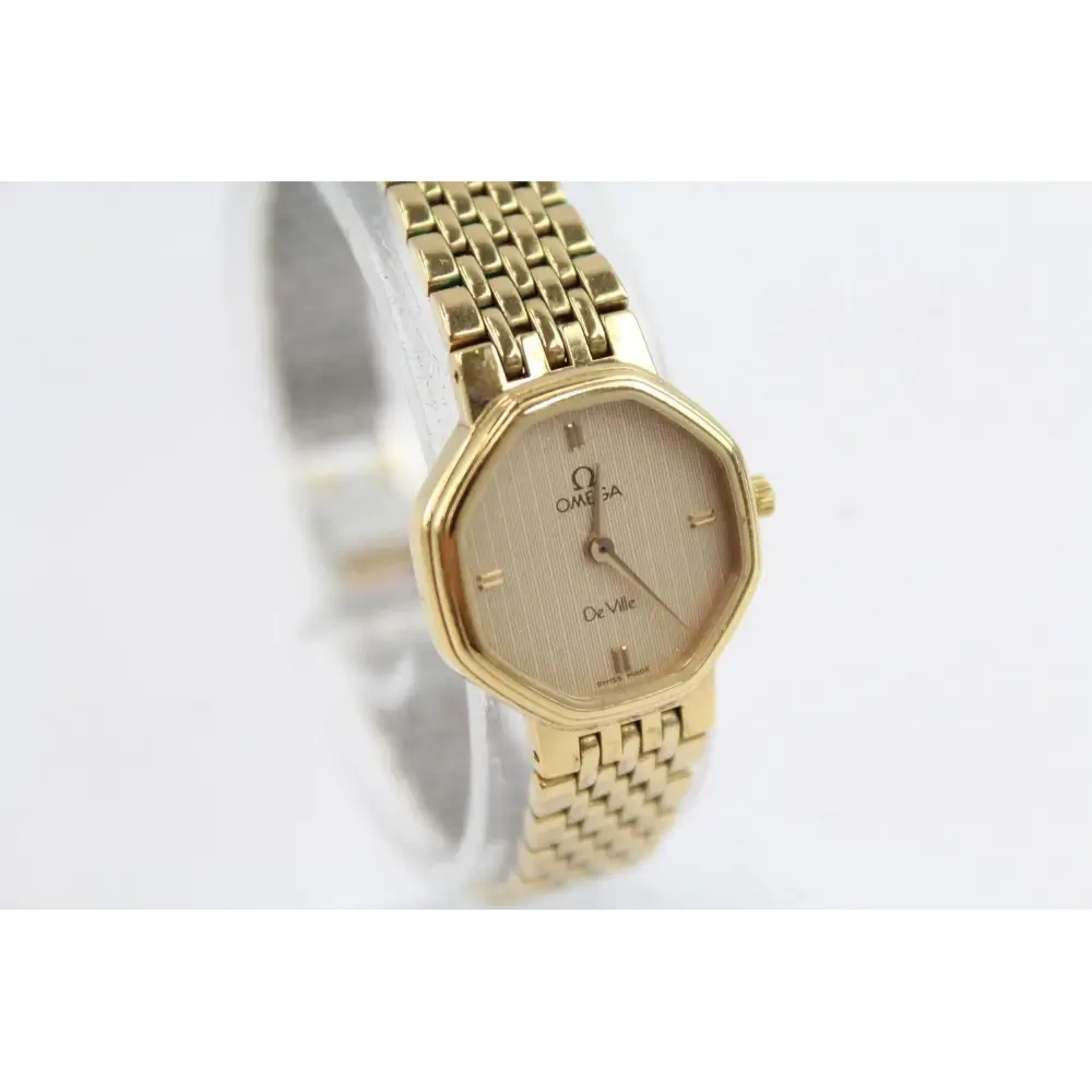 Gold Omega watch on a white background