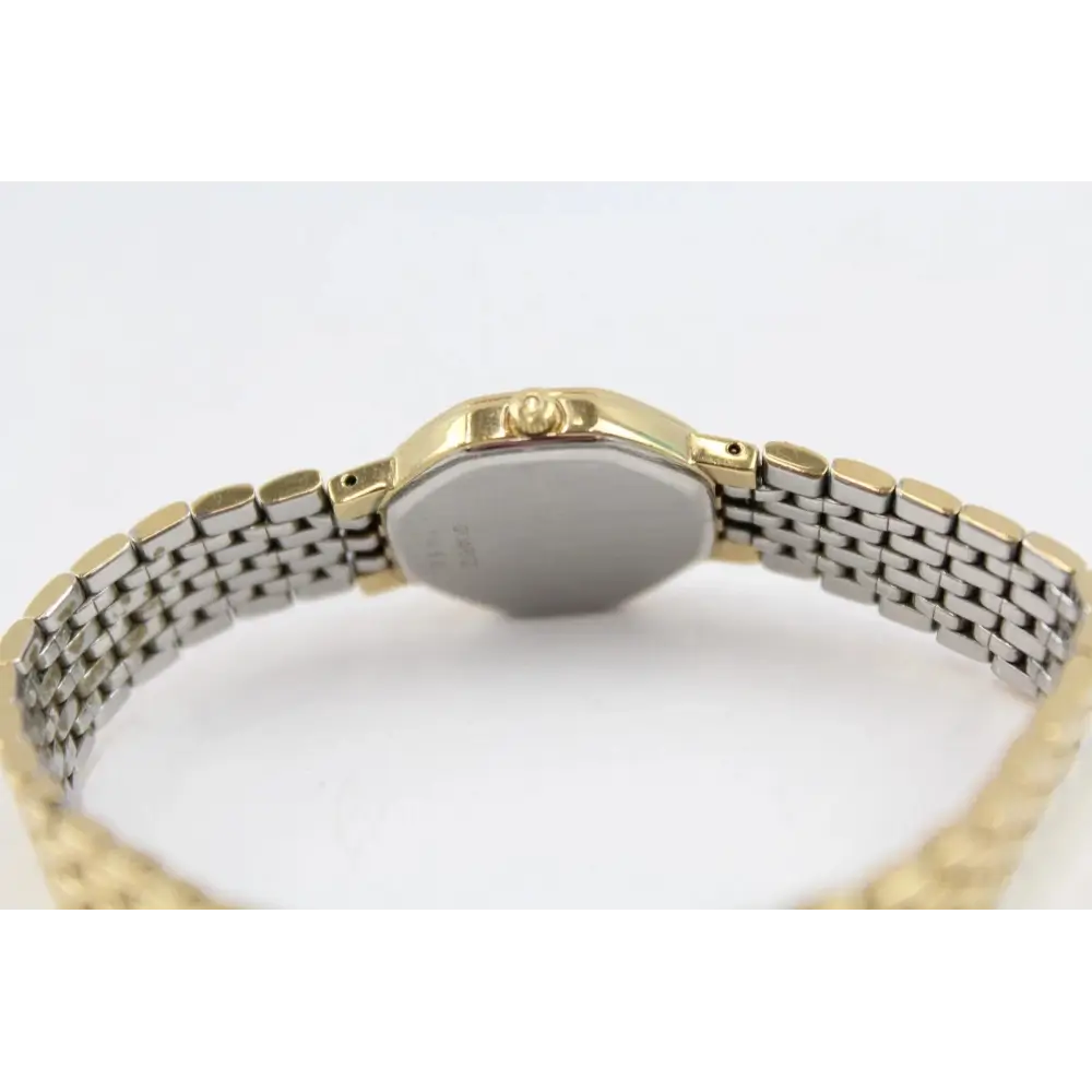 Gold and silver watch on a white background