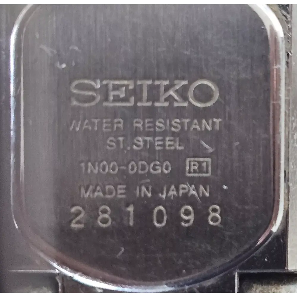 Seiko label on a watch case with water resistance and steel information.