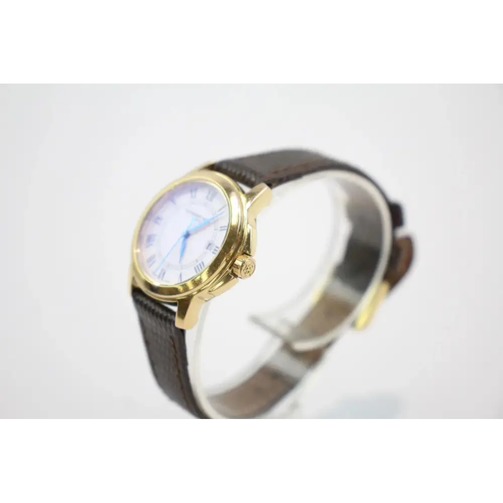Watch with gold case and brown leather strap