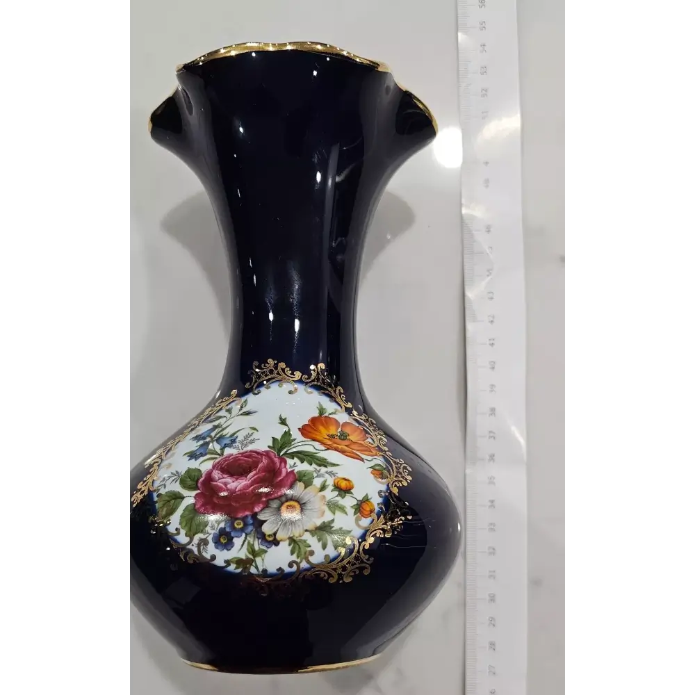 Decorative black vase with floral design and gold accents