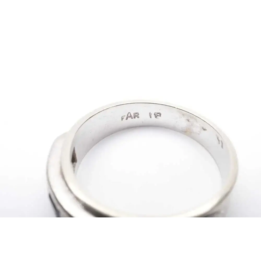 Silver ring with 'FAR 18' engraving on a white background