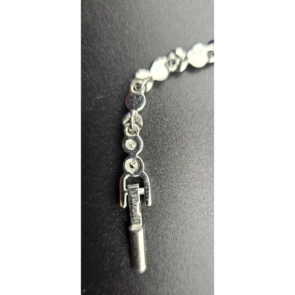 Bracelet with a silver tool charm on a dark background