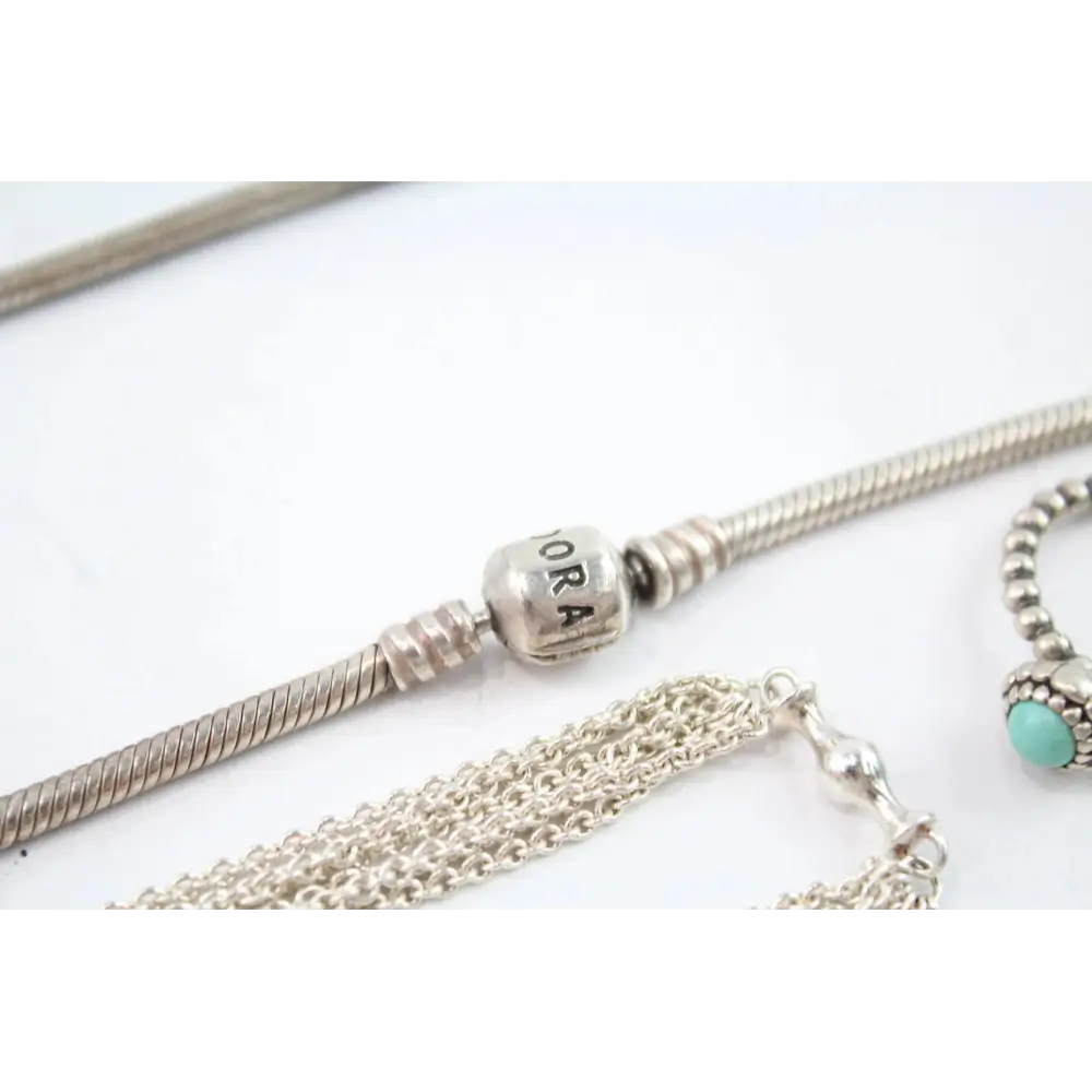 Silver bracelets with charms on a white background