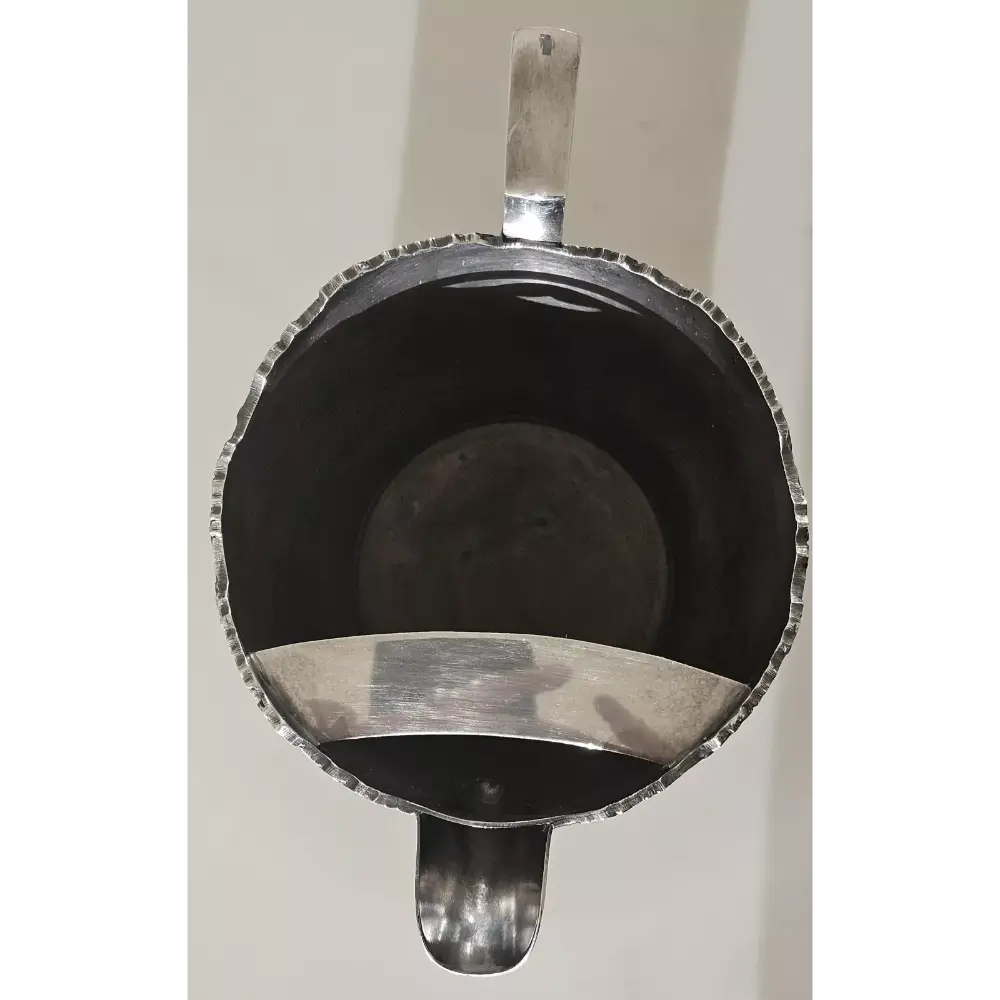 Silver coffee scoop with a black interior