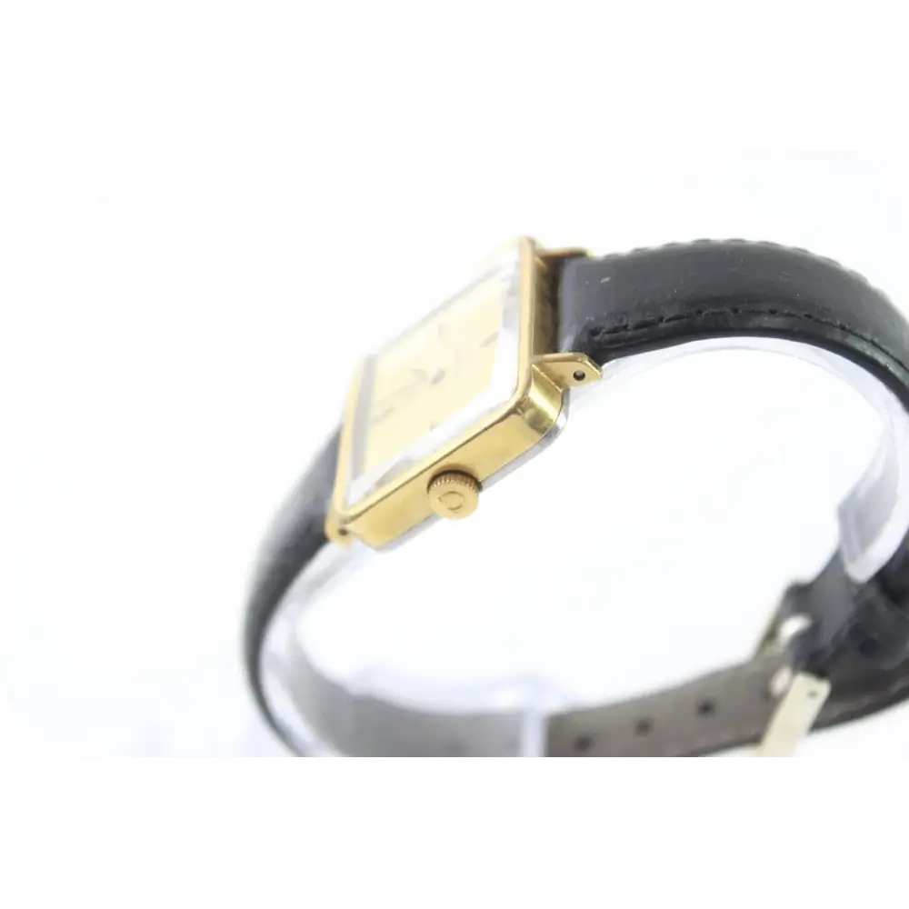 Gold-framed watch with black strap