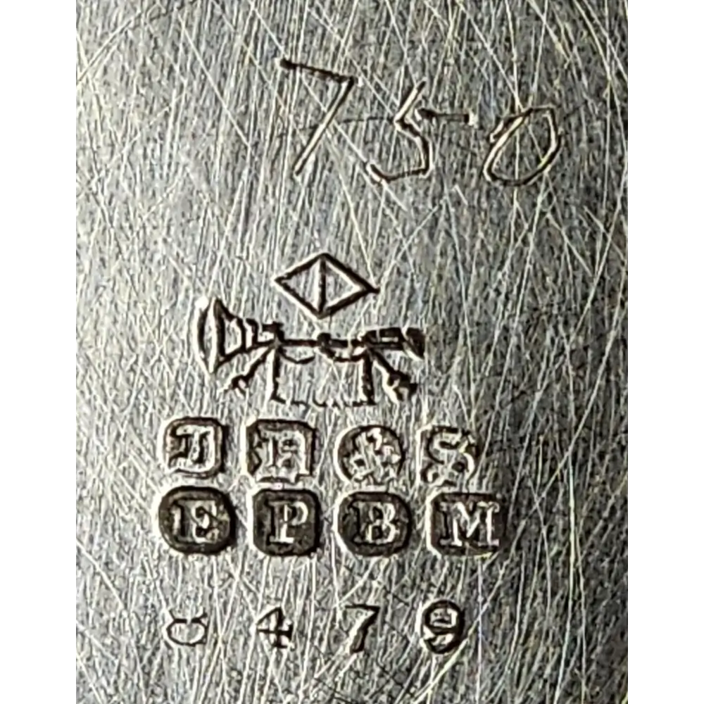 Close-up of a metal surface with engraved text and symbols