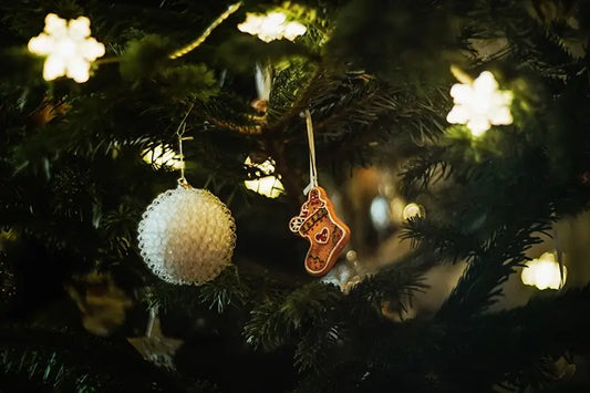 Wedgwood blue jasperware Christmas ornament with white relief details on a dark background.
