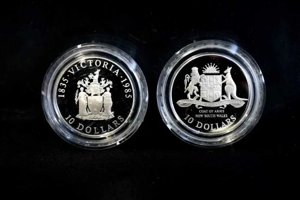 Close-up of 1985 Victoria and 1987 NSW Coat of Arms $10 proof coin designs | Koalaehub