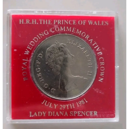 Royal commemorative coin in a red case with text about the Prince of Wales and Lady Diana Spencer's wedding.