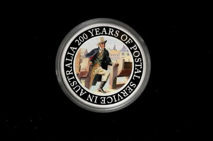 A circular commemorative coin or medallion on a black background, featuring a vintage illustration of a postal worker and the text 'AUSTRALIA 200 YEARS OF POSTAL SERVICE IN AUSTRALIA' around the edge frpom our Gold Proof Sets & Commemorative Medals collection 