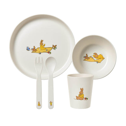 A children's dinnerware set on a white background, including a plate, bowl, cup, fork, and spoon. The white ceramic pieces are decorated with cute cartoon bunnies in yellow outfits doing playful activities from our Royal Doulton Bunnykins Baby Gifts Australia collection 