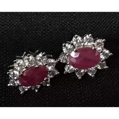 Pair of earrings with red gemstones and silver floral designs 