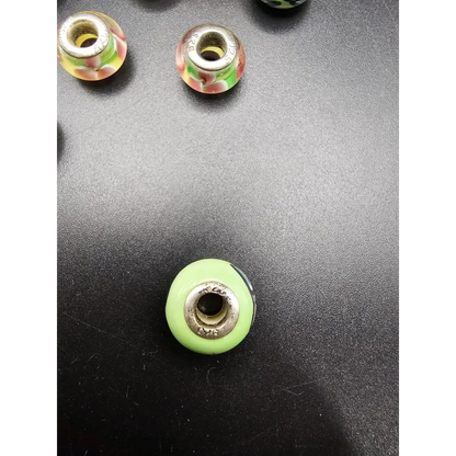 Green glass bead with silver metal core