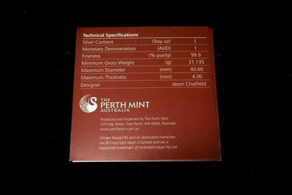 A square reddish-brown product information card showing technical specifications for a Perth Mint silver coin, photographed against a black background.