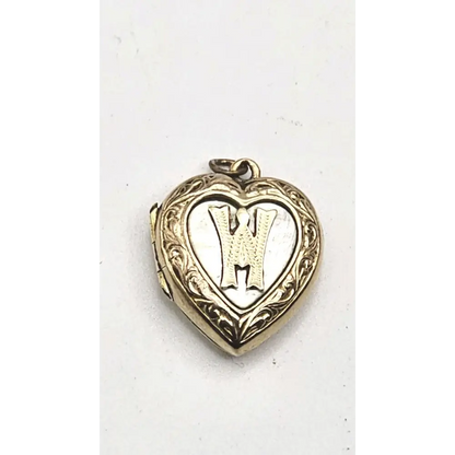 Heart-shaped locket with engraved design on a white background