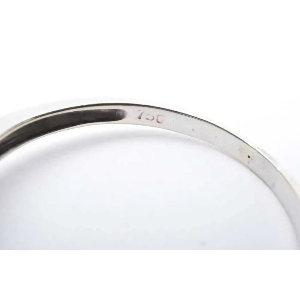 Close-up of a silver ring with '925' stamp on a white background