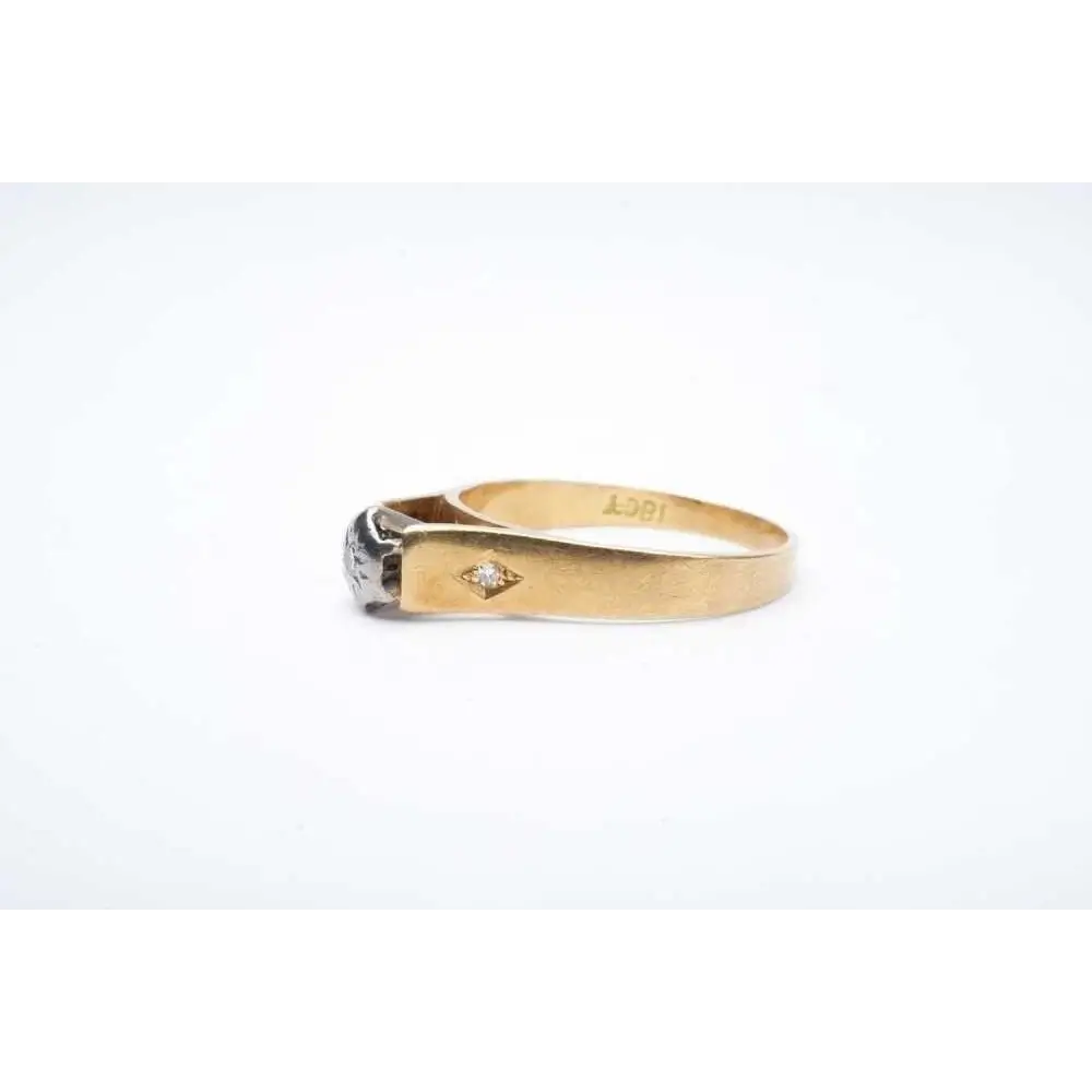 Gold ring with a diamond on a white background
