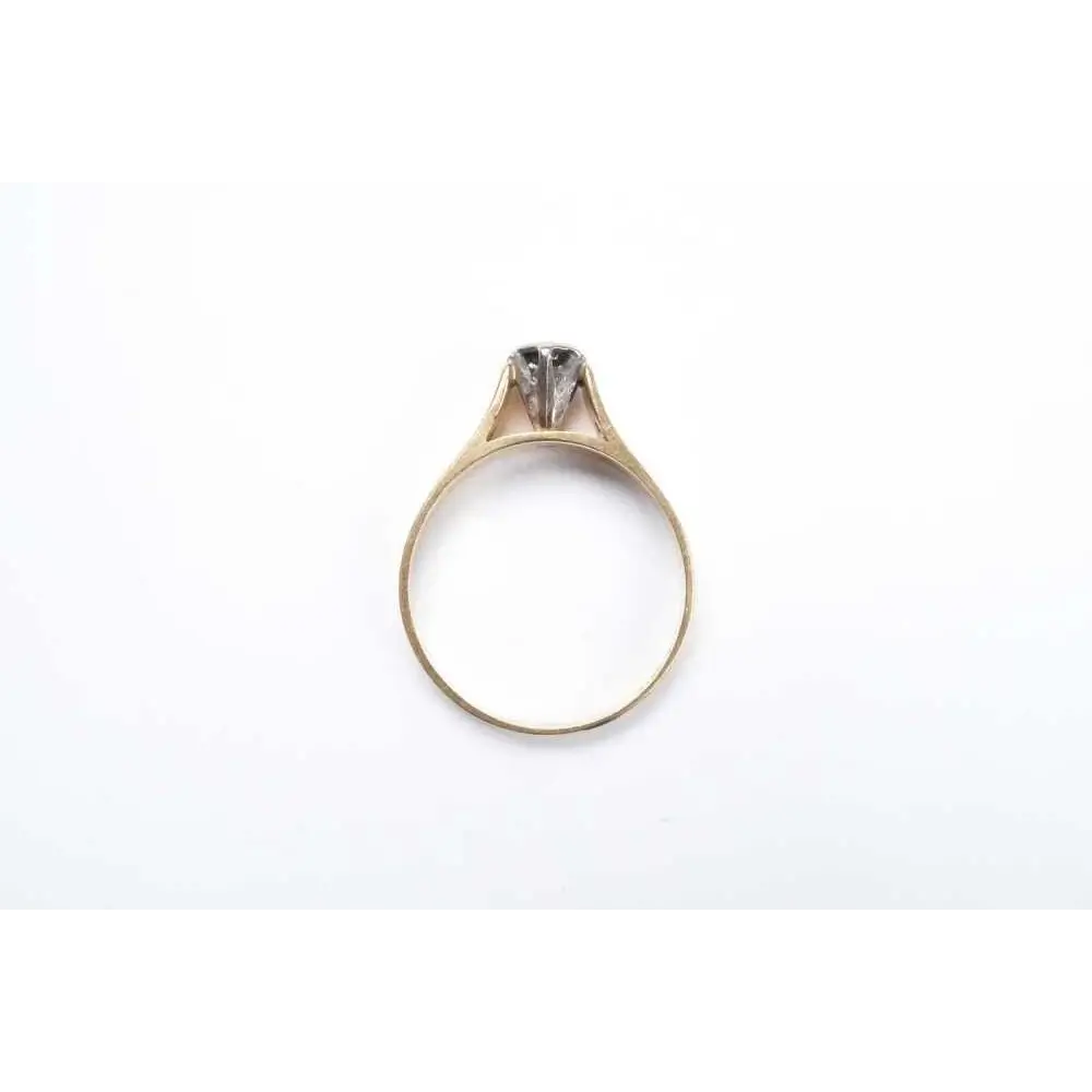 Gold ring with a diamond on a white background
