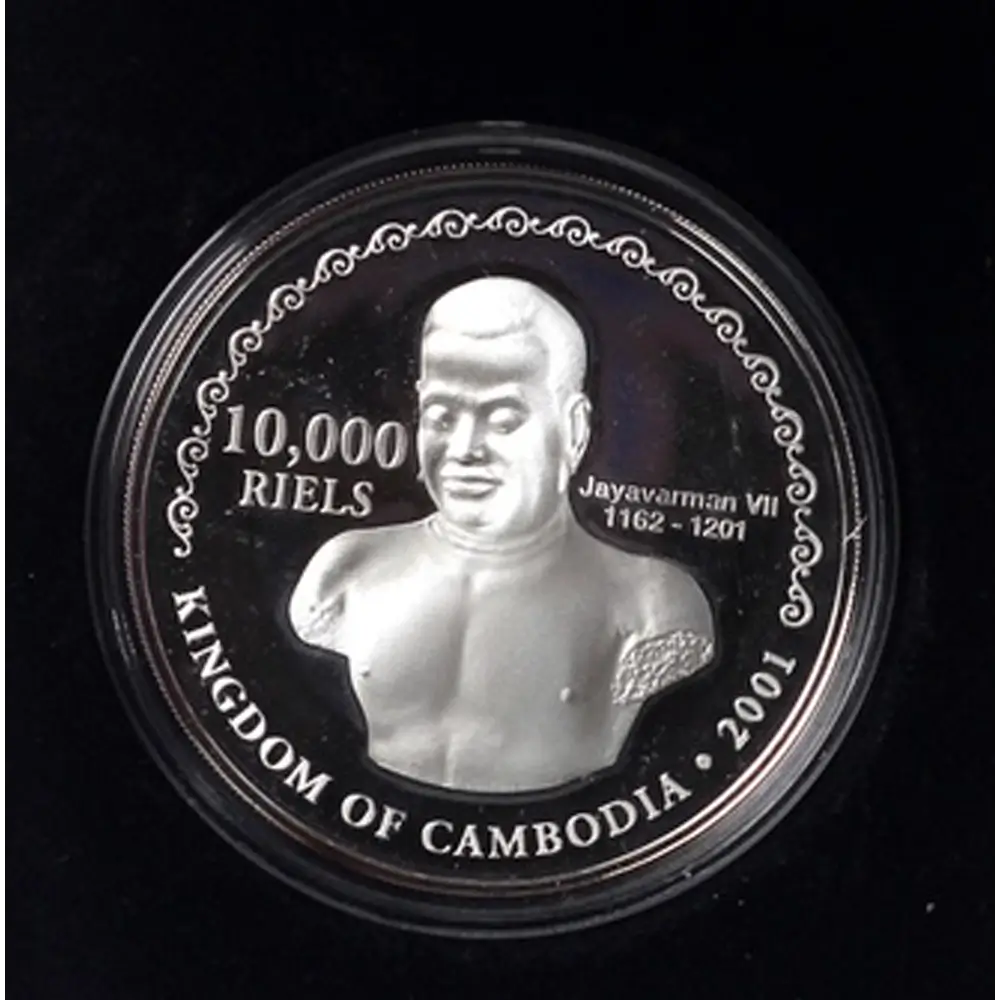 A circular silver coin featuring a relief bust of King Jayavarman VII of Cambodia, with text reading '10,000 RIELS', 'KINGDOM OF CAMBODIA', and '2001', shown inside a clear protective capsule on a black background from our Vintage British Coins & Commemorative Sets Australia collection 