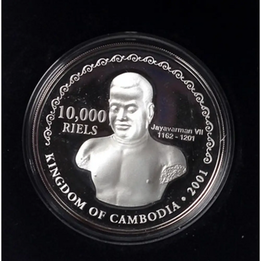 A circular silver coin featuring a relief bust of King Jayavarman VII of Cambodia, with text reading '10,000 RIELS', 'KINGDOM OF CAMBODIA', and '2001', shown inside a clear protective capsule on a black background from our Vintage British Coins & Commemorative Sets Australia collection 