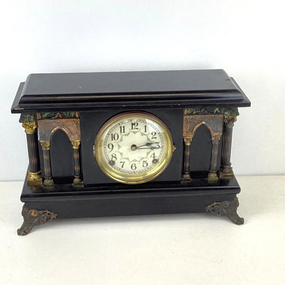 Decorative clock with black and gold design 