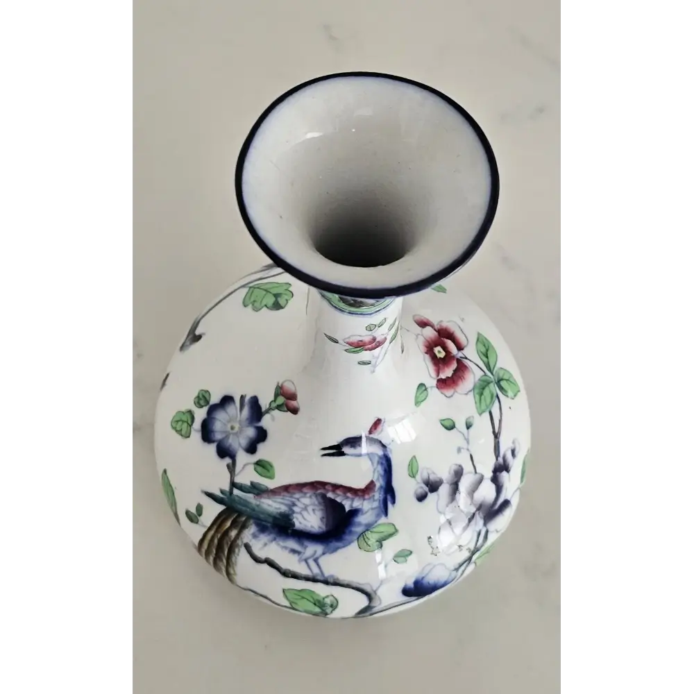 Close-up of the vibrant floral details and rich colors on the English Coronaware Bird of Paradise vase.