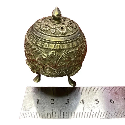 Decorative brass container with intricate designs