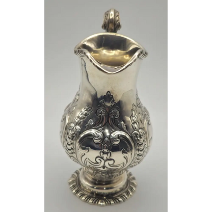 Silver pitcher with intricate designs