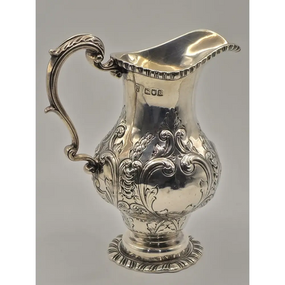 Silver pitcher with intricate designs