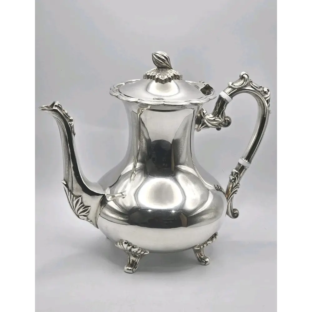 Silver teapot on a light gray 