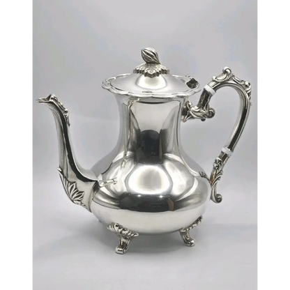 Silver teapot on a light gray 