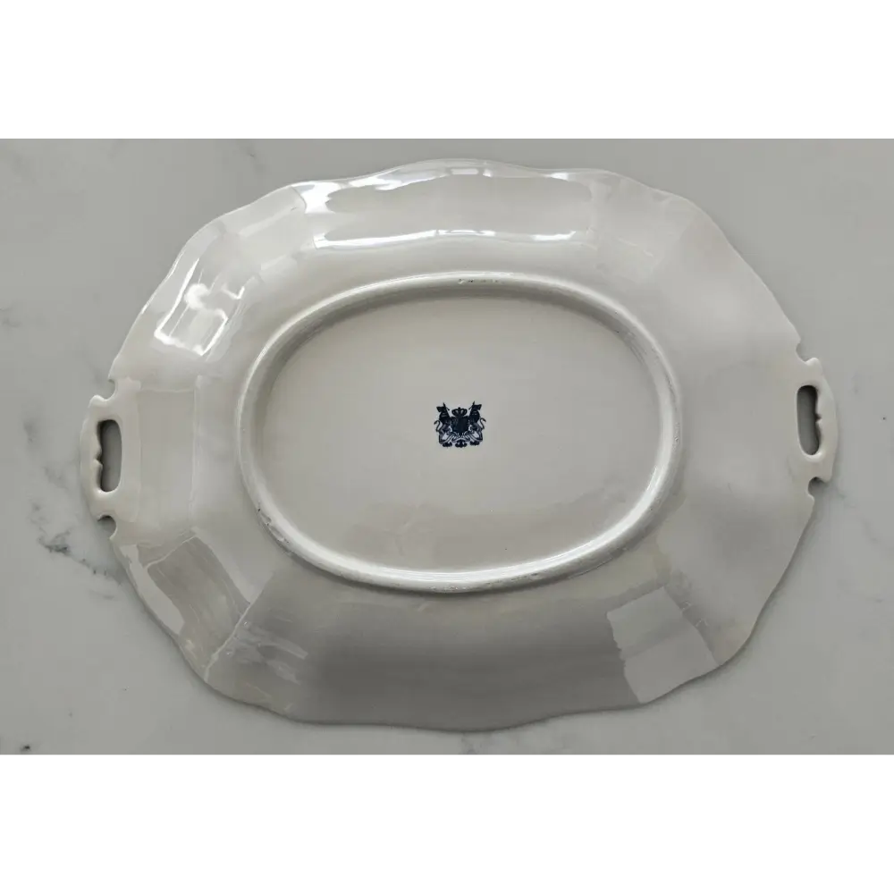 White ceramic platter with handles on a gray background