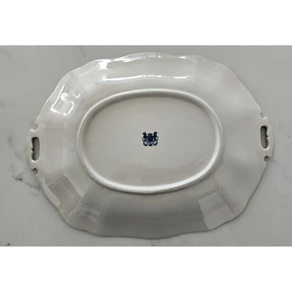 White ceramic platter with handles on a gray background